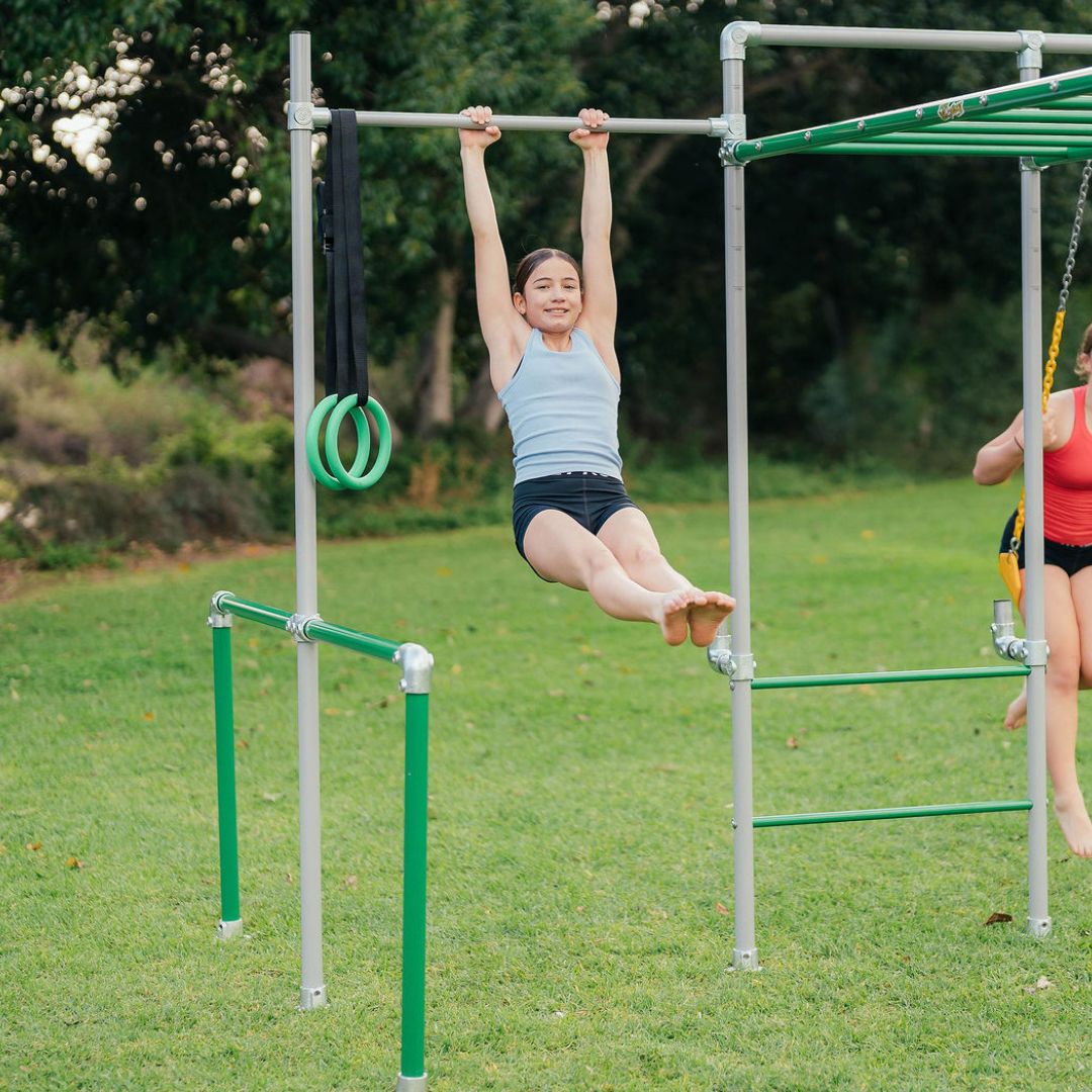 Child using pull up bar on a Funky Monkey Bars backyard monkey bar frame