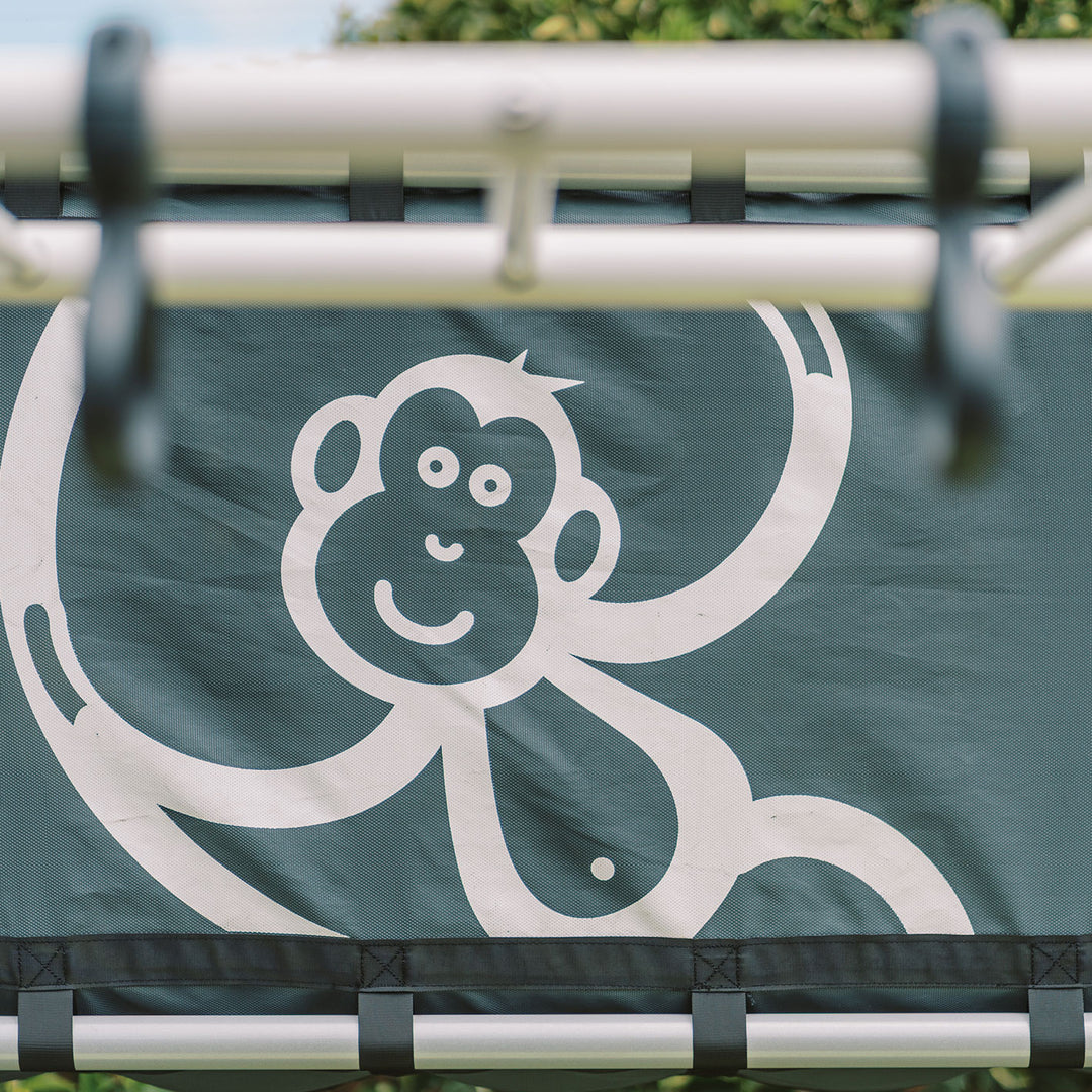 Close-up of black Cubby Clubhouse panel with white monkey logo