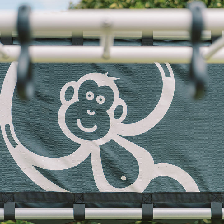 Close-up of black Cubby Clubhouse panel with white monkey logo