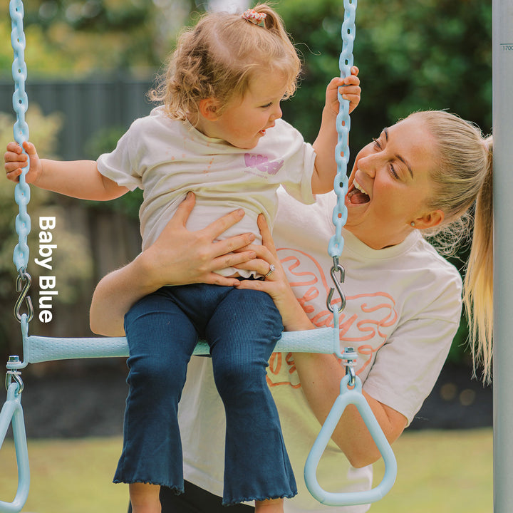 Child using baby blue Funky Monkey Bars Trapeze swing with an adult beside them