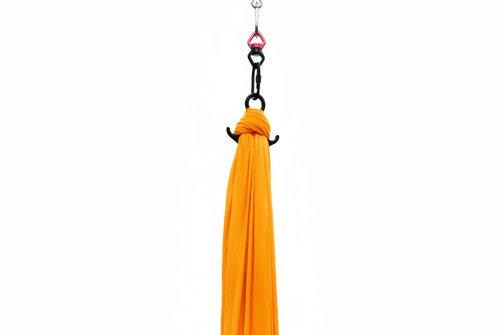 Orange Aerial Silk attached to carabiner and hanging hardware