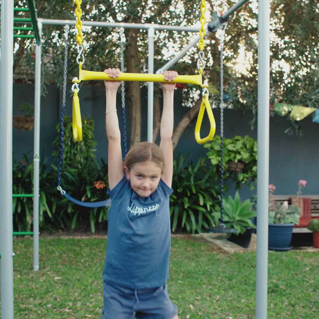 video - child swinging and playing with a yellow trapeze