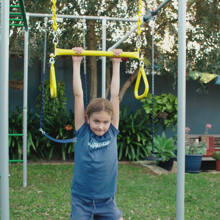 video - child swinging and playing with a yellow trapeze